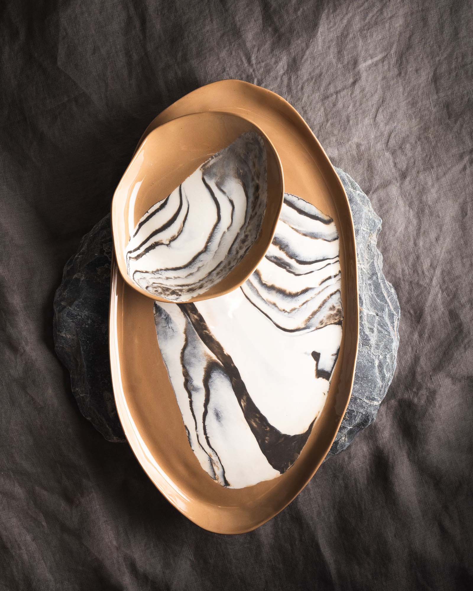 story of space collection (9) Sculptural bowl in black porcelain with layered blue floating glazes and textured exterior